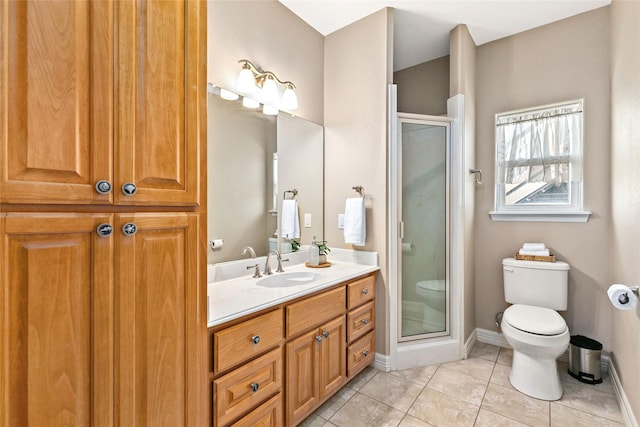 bathroom with tile patterned floors, vanity, toilet, and a shower with shower door