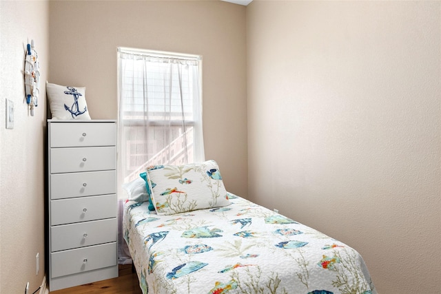 bedroom with hardwood / wood-style flooring