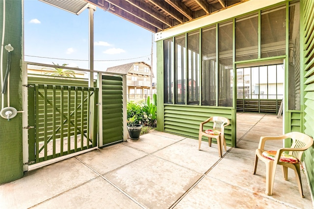 view of patio with a sunroom