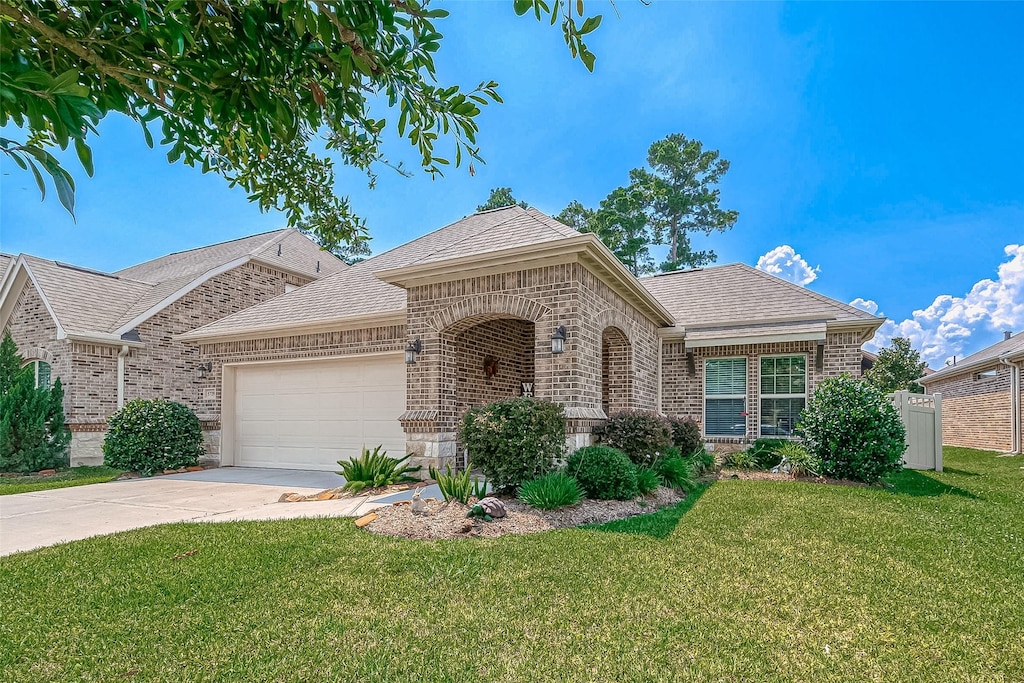 single story home with a garage and a front yard