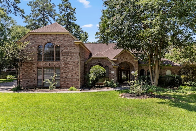 view of front of house with french doors and a front lawn