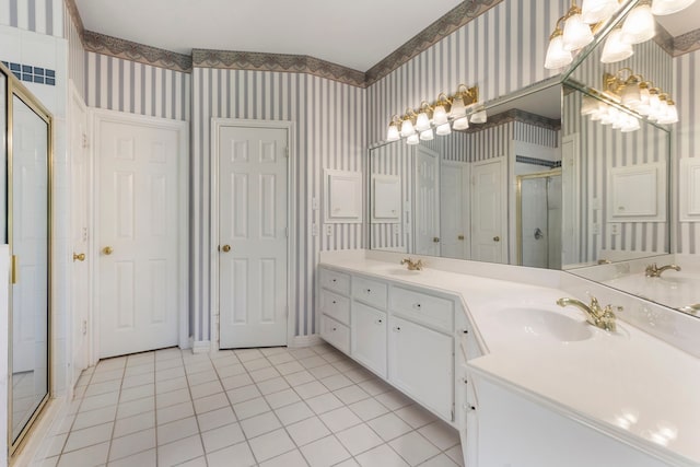 bathroom with tile patterned flooring, vanity, a notable chandelier, and a shower with shower door