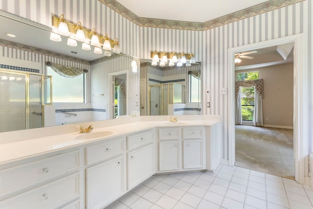 bathroom with walk in shower, a healthy amount of sunlight, tile patterned flooring, and vanity