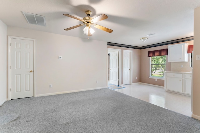 empty room with light colored carpet and ceiling fan