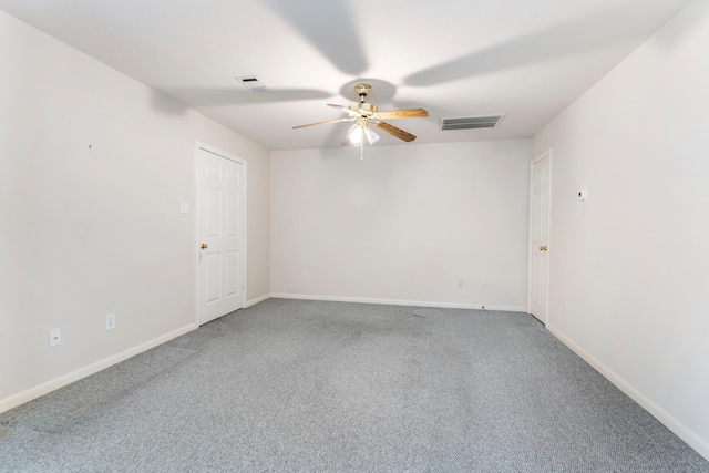 carpeted spare room featuring ceiling fan