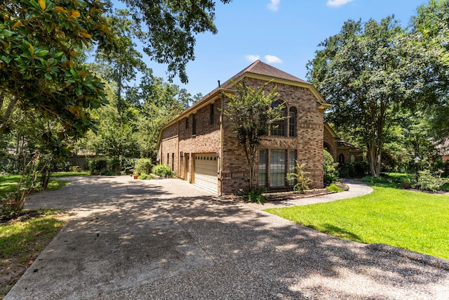 view of front of home with a garage and a front yard