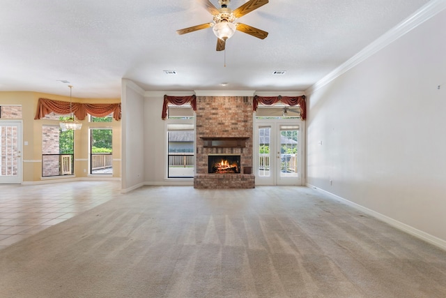 unfurnished living room with french doors, light colored carpet, ornamental molding, and a fireplace