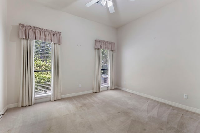 empty room with ceiling fan and light colored carpet