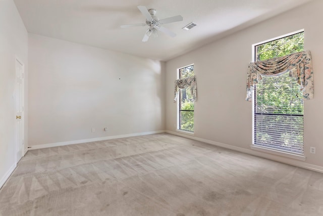 carpeted empty room featuring ceiling fan