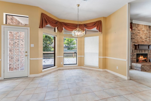 unfurnished dining area with light tile patterned floors, a fireplace, and a chandelier