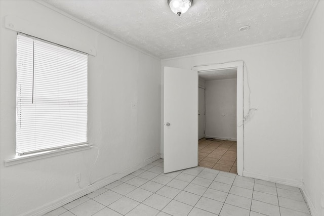 empty room featuring a textured ceiling and light tile floors