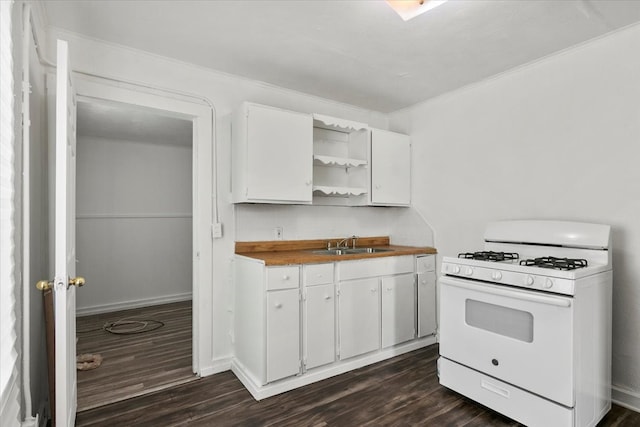 kitchen with white gas range, dark hardwood / wood-style floors, and white cabinets