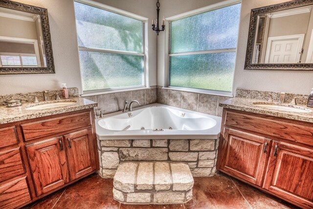 bathroom featuring crown molding, vanity, tile patterned floors, and a bathtub