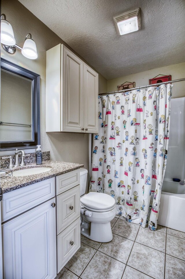 full bathroom with tile patterned floors, toilet, a textured ceiling, vanity, and shower / bathtub combination with curtain