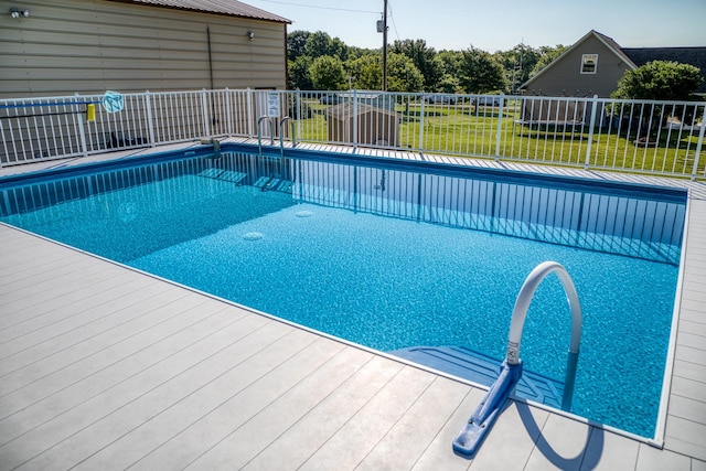 view of pool with a yard