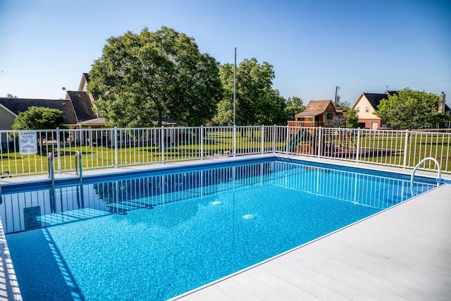 view of swimming pool with a lawn