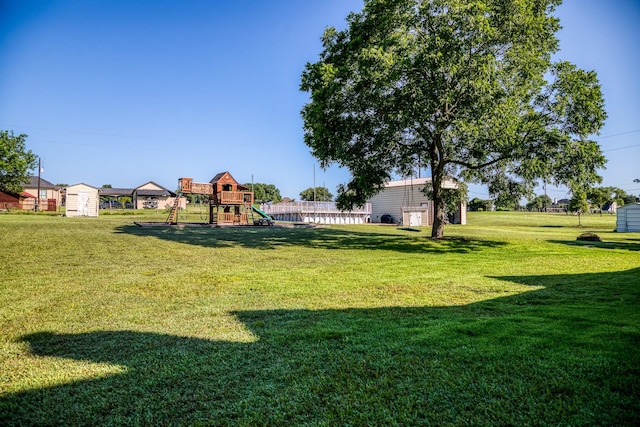 view of yard featuring a playground and a shed