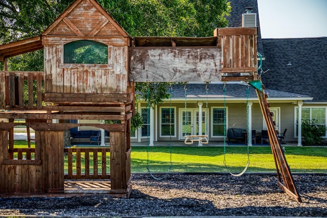 rear view of house with a yard