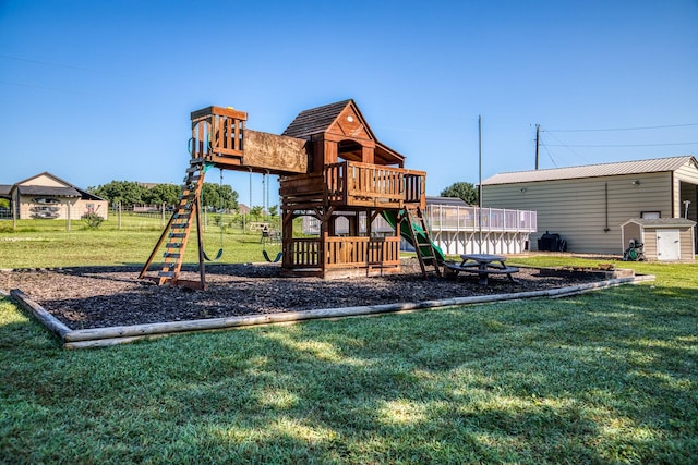 view of jungle gym with a yard and a storage shed