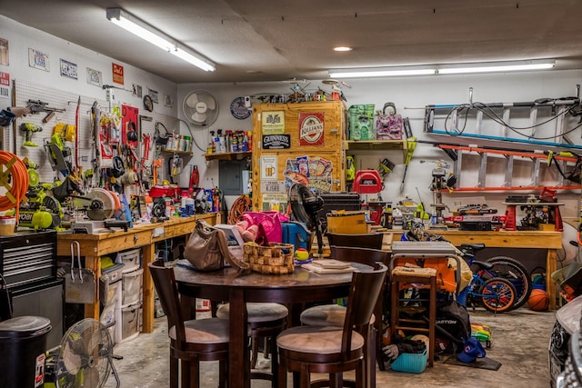 misc room with concrete flooring and a workshop area