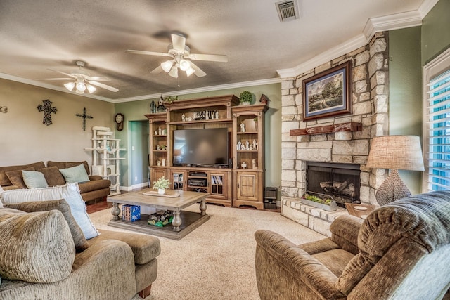 living room with crown molding, ceiling fan, carpet flooring, a stone fireplace, and a textured ceiling