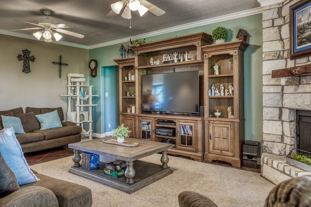 carpeted living room with ceiling fan, ornamental molding, a fireplace, and a textured ceiling