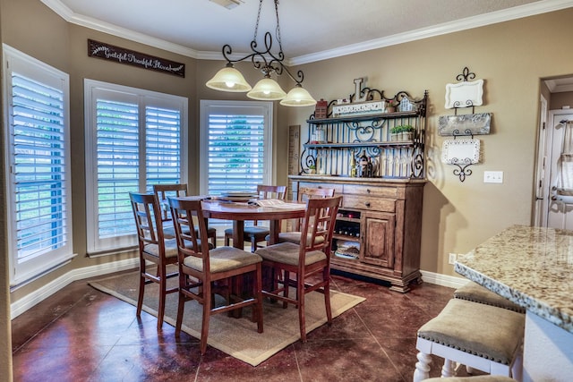 dining space with crown molding and dark tile patterned floors