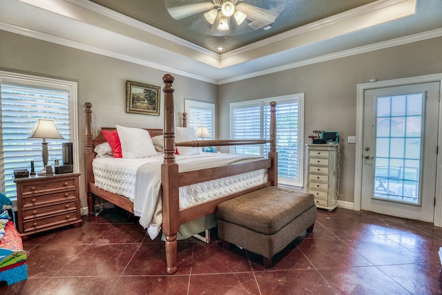 tiled bedroom with ceiling fan, a raised ceiling, a textured ceiling, access to exterior, and ornamental molding