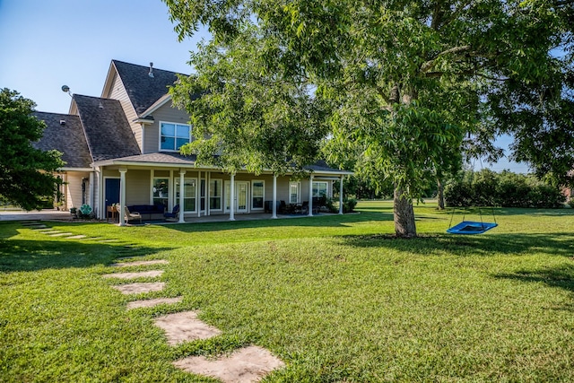 back of house featuring a yard and an outdoor hangout area