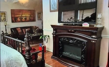 sitting room with a fireplace and wood finished floors