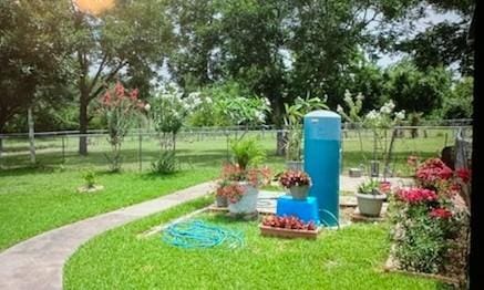 exterior space with a lawn and fence