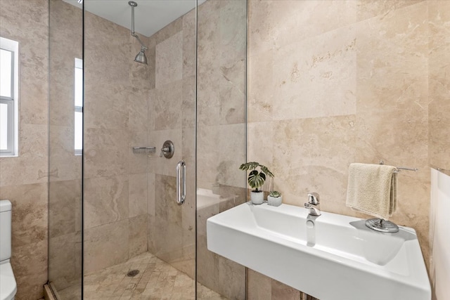 bathroom featuring tile walls, toilet, an enclosed shower, and sink