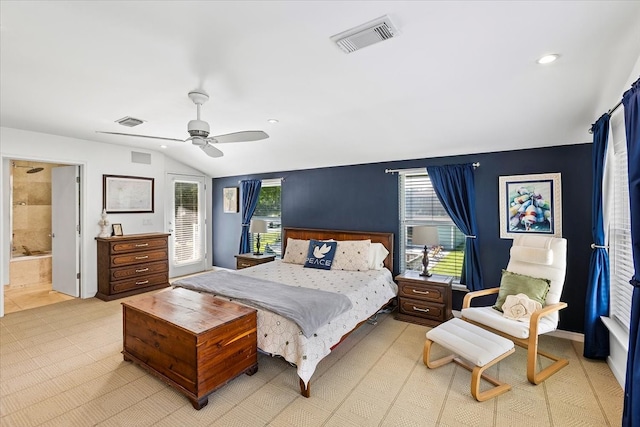 bedroom with ceiling fan, lofted ceiling, and ensuite bath