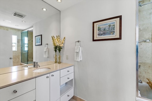 bathroom with vanity and tiled shower / bath