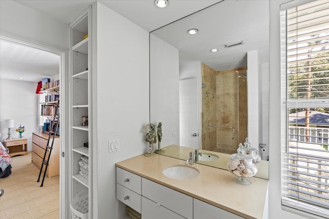 bathroom with a shower with door and vanity