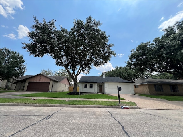 ranch-style home with a front yard and a garage