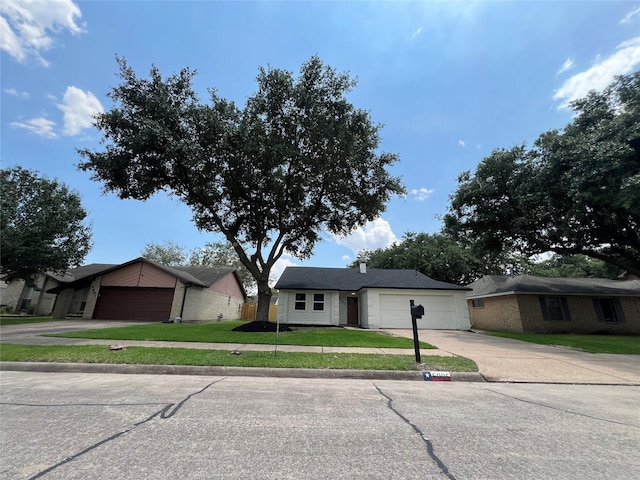 ranch-style house with a garage and a front yard