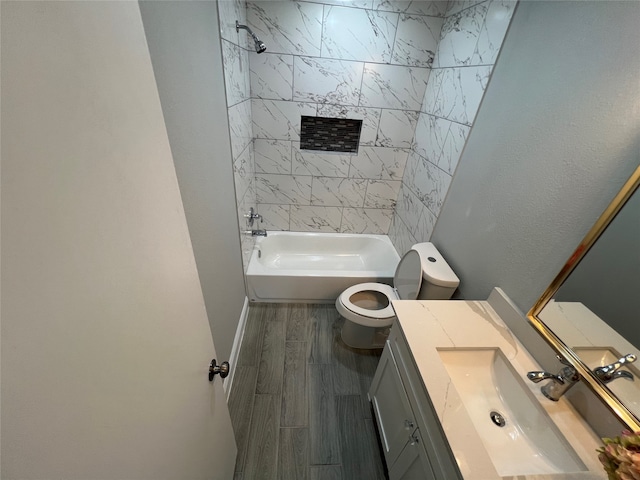 full bathroom featuring hardwood / wood-style flooring, vanity, tiled shower / bath combo, and toilet