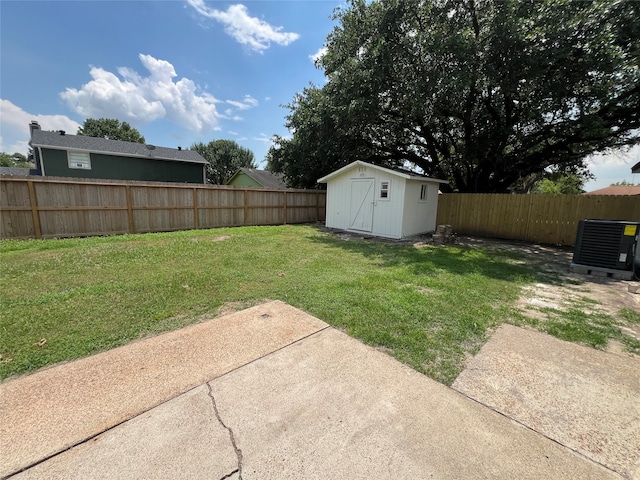 view of yard featuring central air condition unit, a storage shed, and a patio