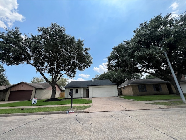 single story home with a front yard and a garage