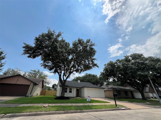 single story home with a garage and a front lawn