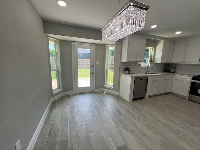 kitchen featuring sink, decorative backsplash, light hardwood / wood-style floors, stainless steel appliances, and white cabinets