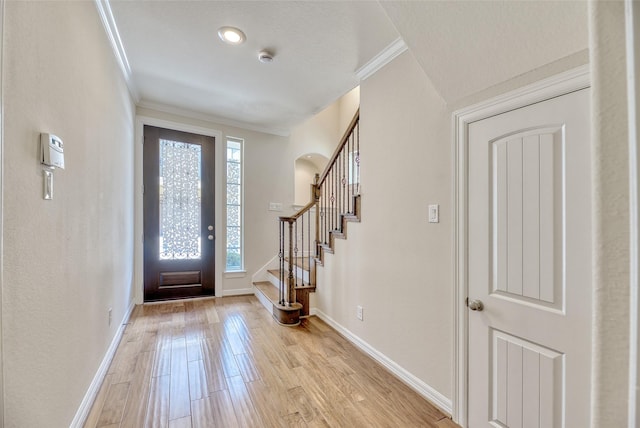 entryway featuring light hardwood / wood-style floors and crown molding