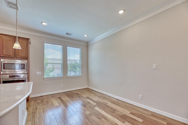 kitchen with decorative light fixtures, light hardwood / wood-style floors, ornamental molding, and appliances with stainless steel finishes