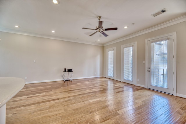 empty room featuring ceiling fan, light hardwood / wood-style floors, and ornamental molding