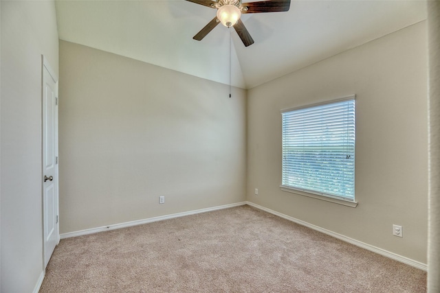 carpeted spare room with ceiling fan and lofted ceiling