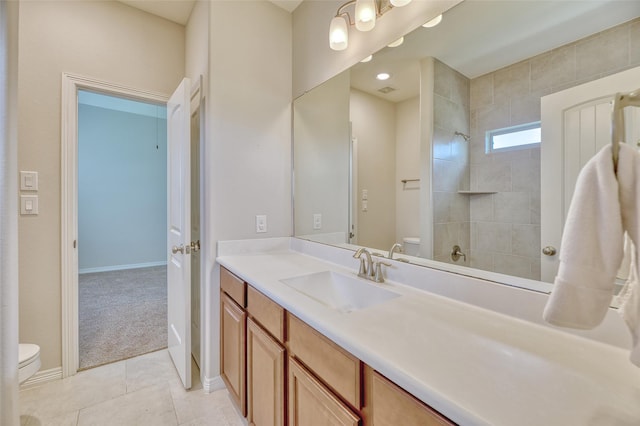 bathroom with tile patterned flooring, vanity, and toilet