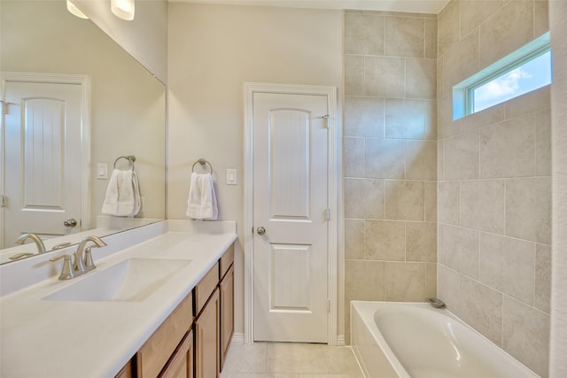 bathroom featuring a tub to relax in, tile patterned flooring, and vanity