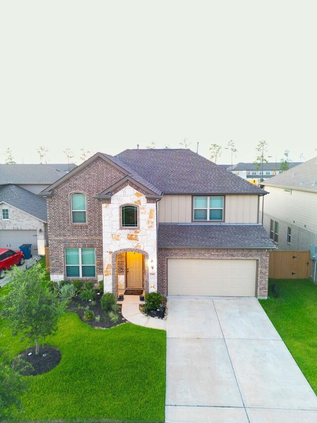 view of front of home with a front lawn and a garage