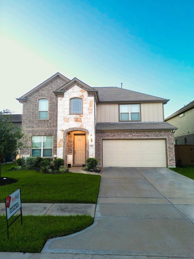 view of front of house with a front yard and a garage